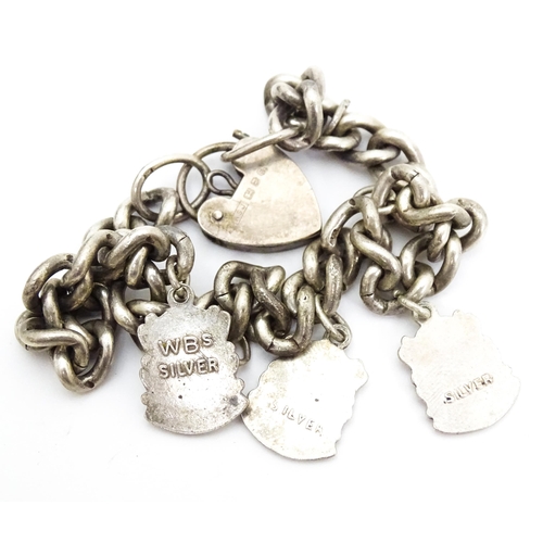 687 - Two silver and white metal charm bracelets set with assorted charms. Together with a quantity of var... 