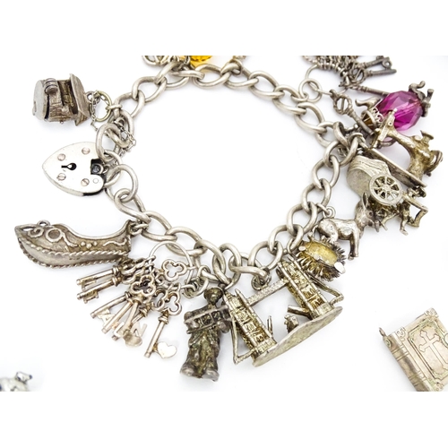 687 - Two silver and white metal charm bracelets set with assorted charms. Together with a quantity of var... 