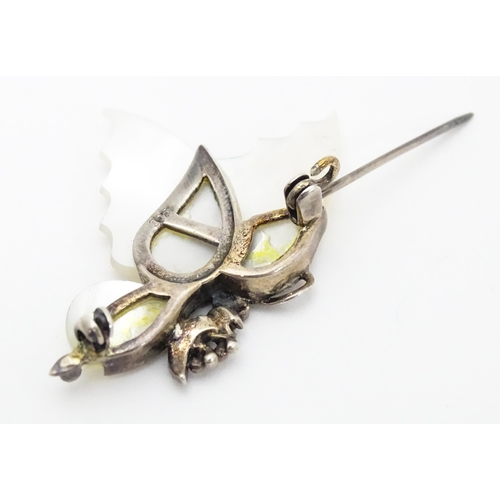 689 - A silver brooch formed as a butterfly set with mother of pearl and marcasite detail. Together with a... 