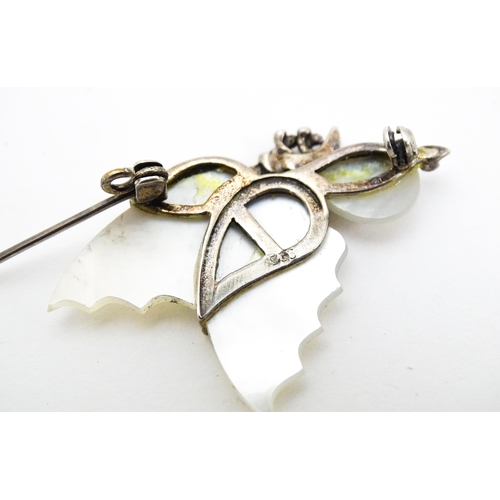 689 - A silver brooch formed as a butterfly set with mother of pearl and marcasite detail. Together with a... 