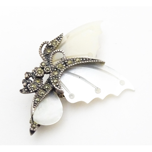 689 - A silver brooch formed as a butterfly set with mother of pearl and marcasite detail. Together with a... 