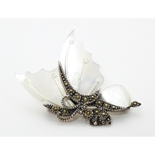 689 - A silver brooch formed as a butterfly set with mother of pearl and marcasite detail. Together with a... 