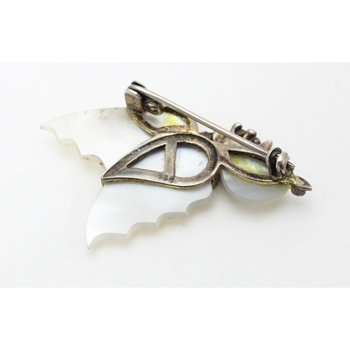 689 - A silver brooch formed as a butterfly set with mother of pearl and marcasite detail. Together with a... 