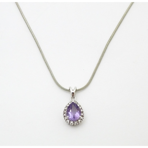 691 - A 9ct white gold pendant set with amethyst bordered by diamonds, on a silver chain. Chain approx. 18... 