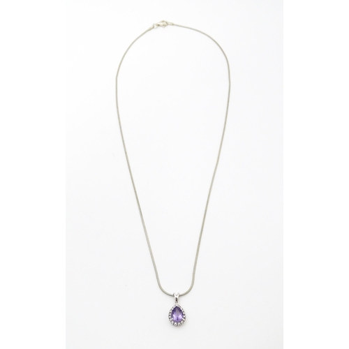 691 - A 9ct white gold pendant set with amethyst bordered by diamonds, on a silver chain. Chain approx. 18... 