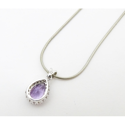 691 - A 9ct white gold pendant set with amethyst bordered by diamonds, on a silver chain. Chain approx. 18... 