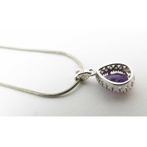 691 - A 9ct white gold pendant set with amethyst bordered by diamonds, on a silver chain. Chain approx. 18... 