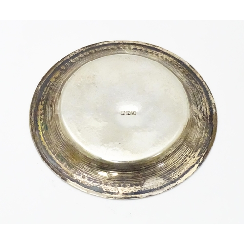 434 - An Egyptian silver pin dish together with a silver teaspoon hallmarked Sheffield 1930 and a white me... 