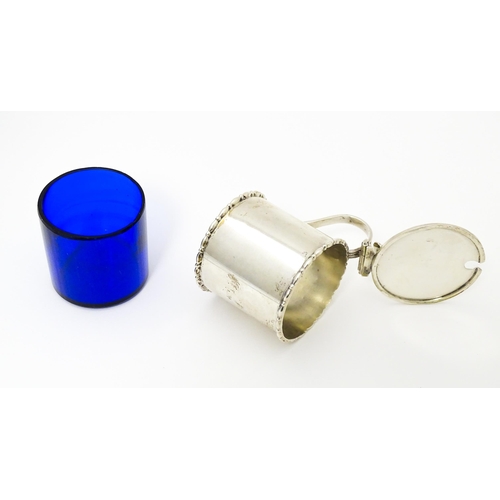 435 - A silver mustard pot with blue glass liner. Hallmarked Birmingham 1910 maker Elkington & Co Ltd. App... 