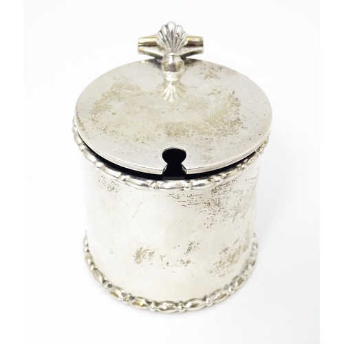 435 - A silver mustard pot with blue glass liner. Hallmarked Birmingham 1910 maker Elkington & Co Ltd. App... 