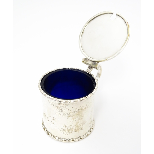 435 - A silver mustard pot with blue glass liner. Hallmarked Birmingham 1910 maker Elkington & Co Ltd. App... 