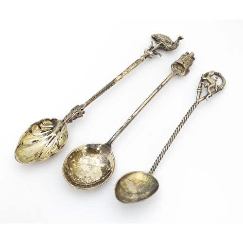 438 - Three silver teaspoons, one hallmarked Birmingham 1978, surmounted by a finial modelled as a turret ... 