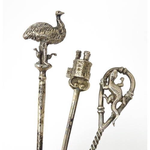 438 - Three silver teaspoons, one hallmarked Birmingham 1978, surmounted by a finial modelled as a turret ... 