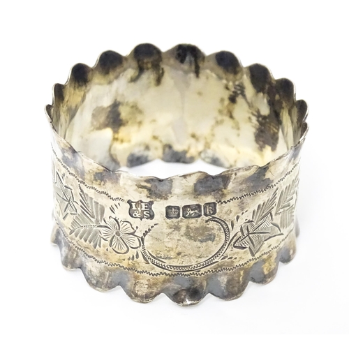 450 - A silver napkin ring with engraved floral and foliate decoration hallmarked Sheffield 1902, maker Is... 