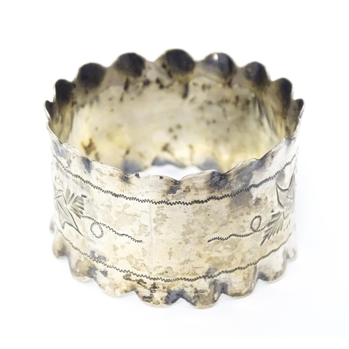 450 - A silver napkin ring with engraved floral and foliate decoration hallmarked Sheffield 1902, maker Is... 