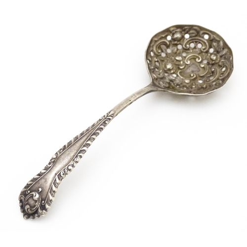 456 - A silver sifter spoon with embossed and pierced detail to bowl, hallmarked Sheffield 1903, maker Wil... 