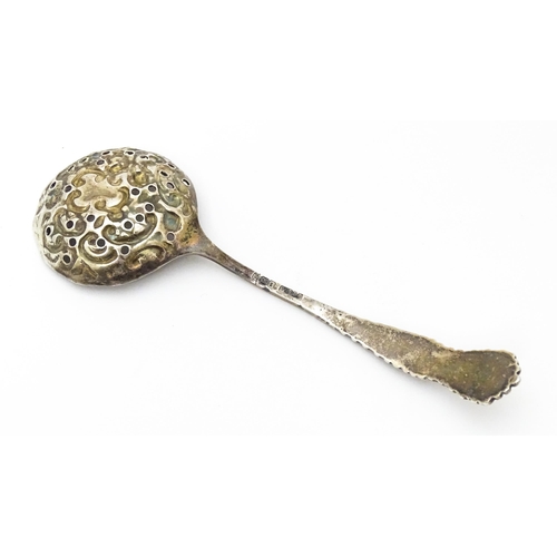 456 - A silver sifter spoon with embossed and pierced detail to bowl, hallmarked Sheffield 1903, maker Wil... 