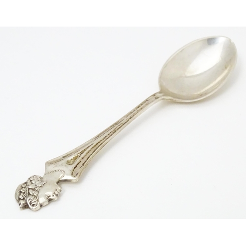 458 - A silver commemorative / souvenir spoon the handle surmounted by an image of Queen Elizabeth II, hal... 