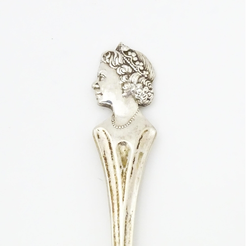 458 - A silver commemorative / souvenir spoon the handle surmounted by an image of Queen Elizabeth II, hal... 