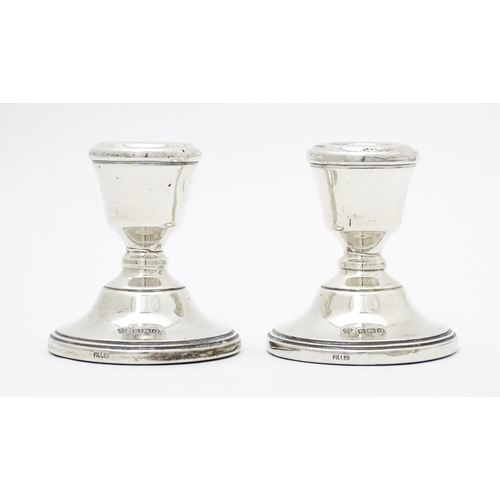 486 - A pair of silver short candlesticks hallmarked Birmingham 1979, maker ESC. Approx. 2 3/4