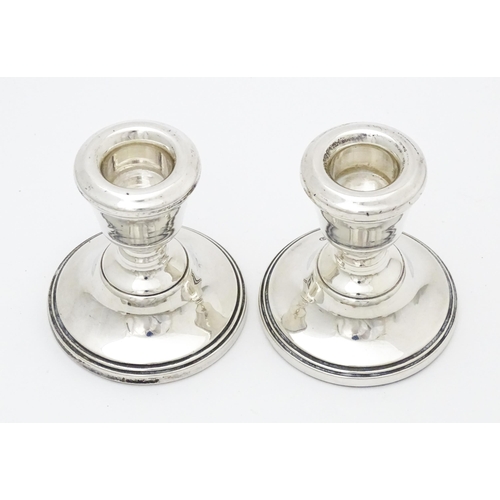 486 - A pair of silver short candlesticks hallmarked Birmingham 1979, maker ESC. Approx. 2 3/4