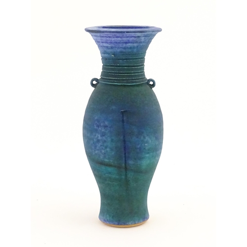 106 - A 20thC studio pottery barium glaze vase by Simon Shaw, with a bulbous body and a flared rim, the ne... 