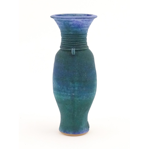 106 - A 20thC studio pottery barium glaze vase by Simon Shaw, with a bulbous body and a flared rim, the ne... 