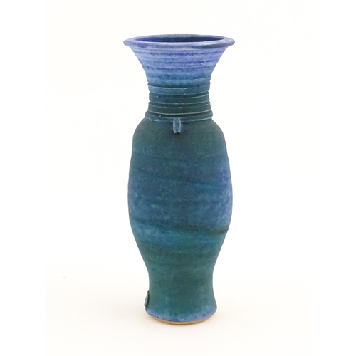 106 - A 20thC studio pottery barium glaze vase by Simon Shaw, with a bulbous body and a flared rim, the ne... 