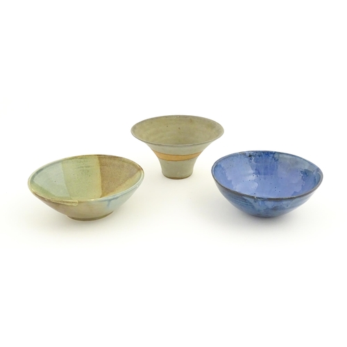 111 - Three studio pottery bowls comprising a bowl with abstract detail signed under Jam, a blue glazed ex... 