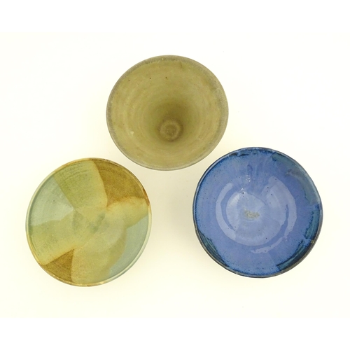 111 - Three studio pottery bowls comprising a bowl with abstract detail signed under Jam, a blue glazed ex... 