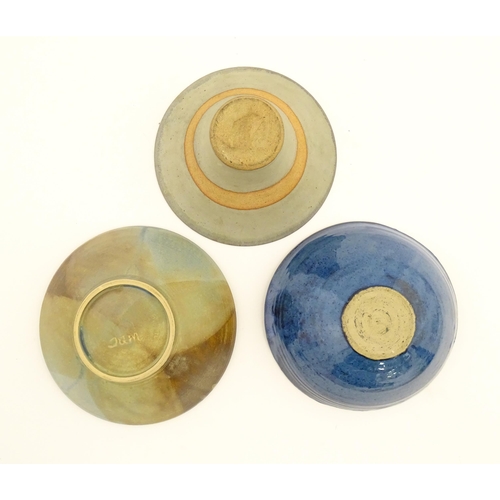 111 - Three studio pottery bowls comprising a bowl with abstract detail signed under Jam, a blue glazed ex... 