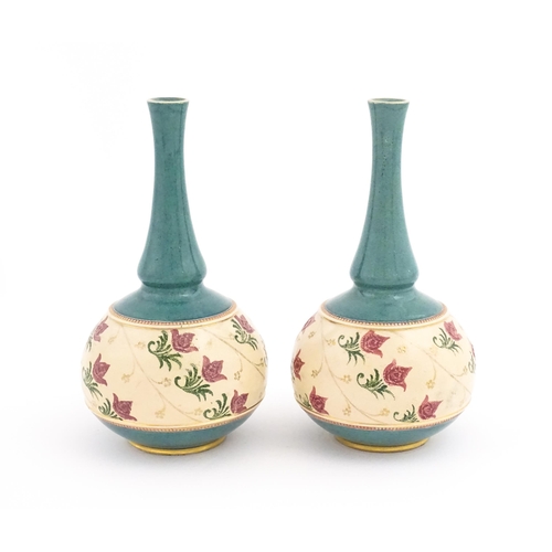 120 - A pair Royal Doulton bottle vases with turquoise ground and banded pink rose detail. Marked under. A... 