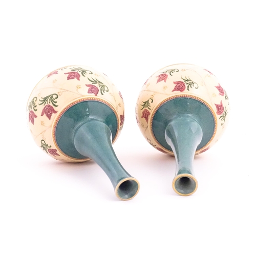 120 - A pair Royal Doulton bottle vases with turquoise ground and banded pink rose detail. Marked under. A... 