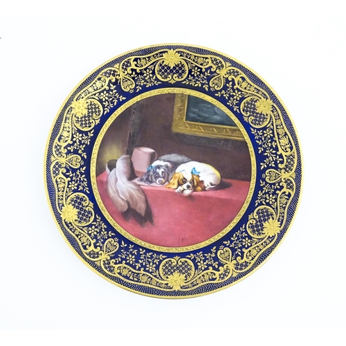 132 - A Paragon plate hand painted by F. Micklewright The Cavalier's Pets after Sir Edwin Landseer. Signed... 