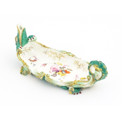 134 - A 19thC Continental dish modelled as a recumbent crocodile / alligator with hand painted floral deta... 