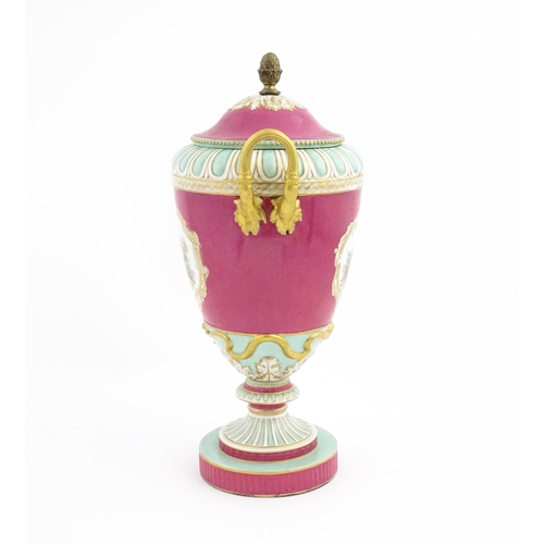 136 - A large KPM pedestal vase and cover of twin handled urn form, the pink ground decorated with vignett... 