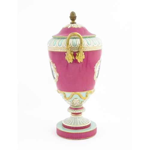 136 - A large KPM pedestal vase and cover of twin handled urn form, the pink ground decorated with vignett... 