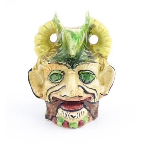 142 - A Thomas Forester & Sons majolica figural devil head jug / vase. Marked under. Approx. 7 1/4