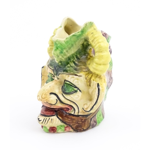 142 - A Thomas Forester & Sons majolica figural devil head jug / vase. Marked under. Approx. 7 1/4