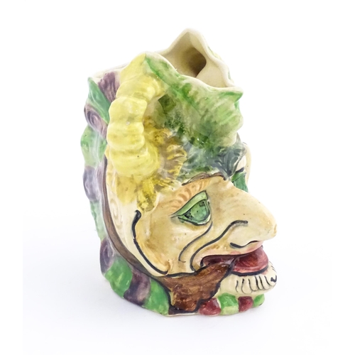 142 - A Thomas Forester & Sons majolica figural devil head jug / vase. Marked under. Approx. 7 1/4