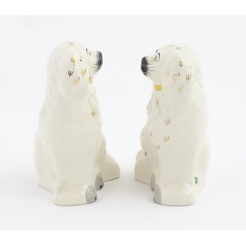 144 - A pair of Beswick Staffordshire dogs with gilt highlights. Approx. 7 3/4