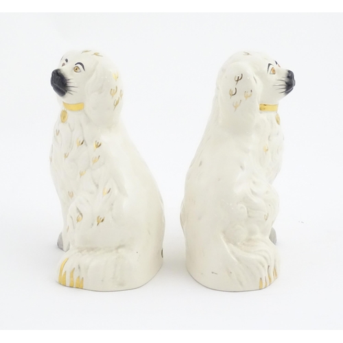 144 - A pair of Beswick Staffordshire dogs with gilt highlights. Approx. 7 3/4