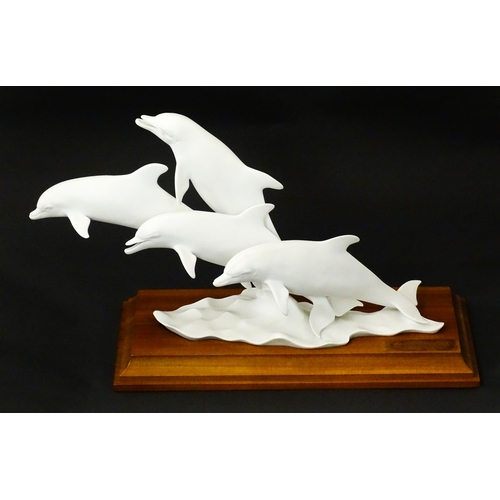 151 - A limited edition Kaiser bisque porcelain group depicting four bottlenose dolphins. Limited edition ... 