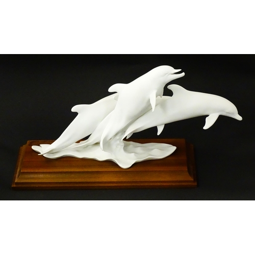 151 - A limited edition Kaiser bisque porcelain group depicting four bottlenose dolphins. Limited edition ... 