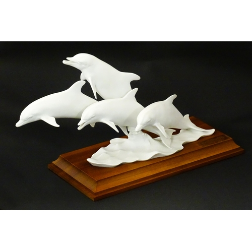 151 - A limited edition Kaiser bisque porcelain group depicting four bottlenose dolphins. Limited edition ... 