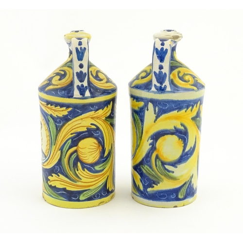 175 - Two Italian maiolica twin handled bottle jars, each decorated with foliate detail and a portrait bus... 