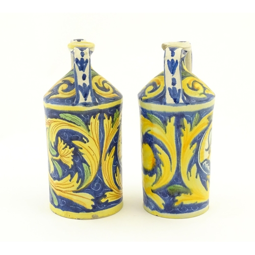 175 - Two Italian maiolica twin handled bottle jars, each decorated with foliate detail and a portrait bus... 