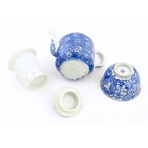 56 - A Chinese blue and white teapot decorated with prunus blossom. Together with a Chinese blue and whit... 