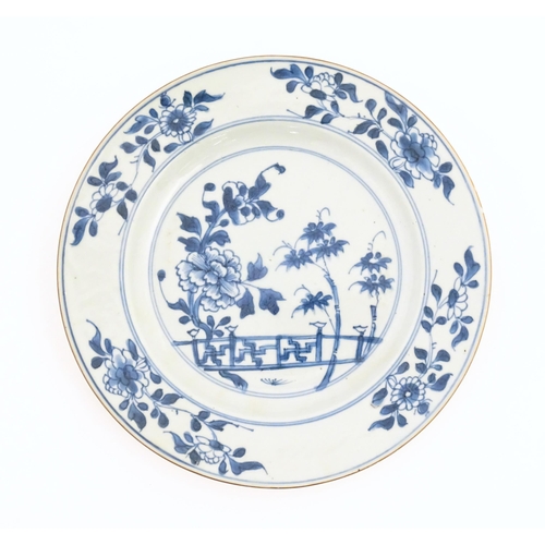 60 - Two Chinese blue and white plates decorated with a peony flower in a garden, with floral border. Bot... 