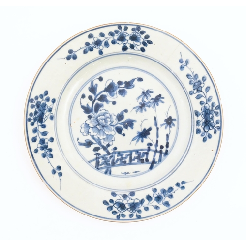 60 - Two Chinese blue and white plates decorated with a peony flower in a garden, with floral border. Bot... 